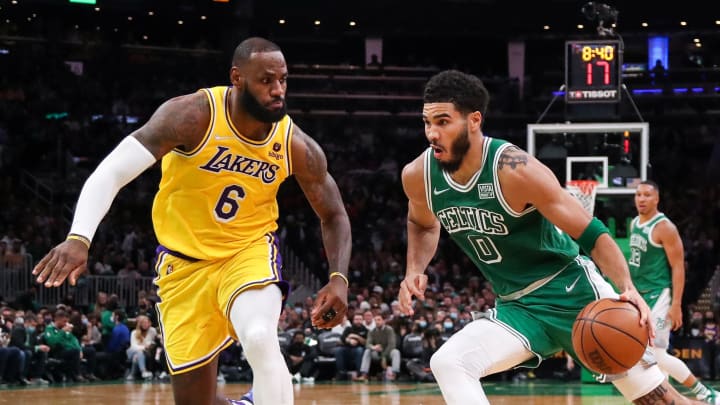 Nov 19, 2021; Boston, Massachusetts, USA; Boston Celtics forward Jayson Tatum (0) drives to the basket defended by Los Angeles Lakers forward LeBron James (6) during the second half at TD Garden. 