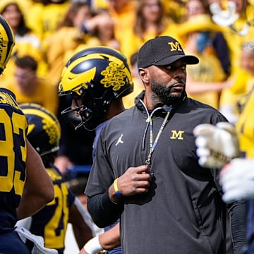 Michigan head coach Sherrone Moore, center, watches warmups before the No. 9 Wolverines' 31-12 loss to No. 3 Texas at Michigan Stadium in Ann Arbor on Saturday, Sept. 7, 2024.