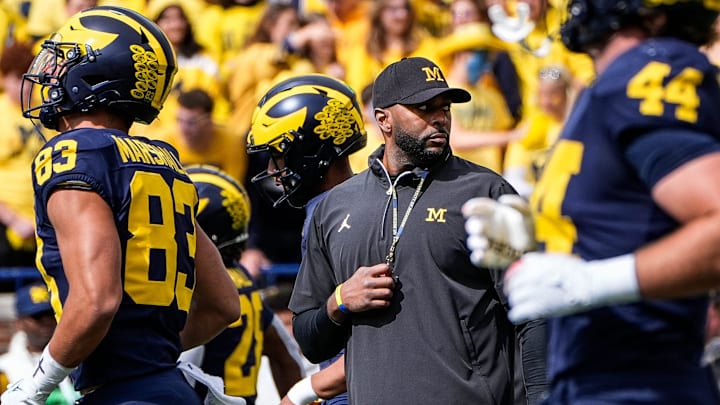 Michigan head coach Sherrone Moore, center, watches warmups before the No. 9 Wolverines' 31-12 loss to No. 3 Texas at Michigan Stadium in Ann Arbor on Saturday, Sept. 7, 2024.