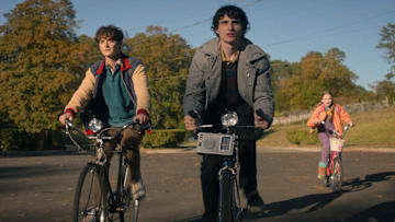 STRANGER THINGS: SEASON 5. (L to R) Noah Schnapp as Will Byers, Finn Wolfhard as Mike Wheeler, and Nell Fisher as Holly Wheeler in Stranger Things: Season 5. 