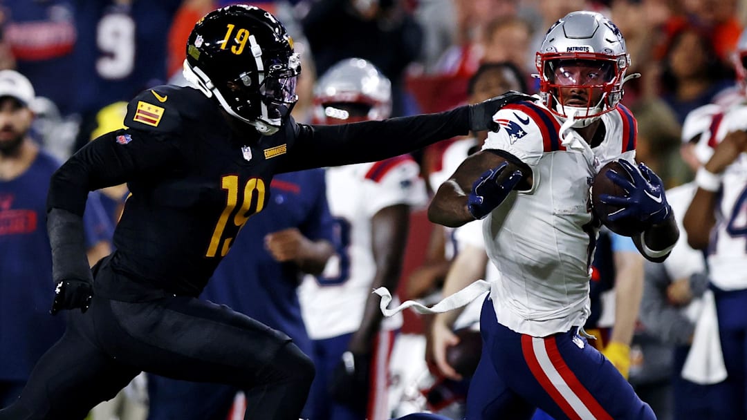 New England Patriots wide receiver Ja'Lynn Polk (1) runs after a catch against Washington Commanders cornerback Noah Igbinoghene (19) during the first quarter during a preseason game at Commanders Field. 