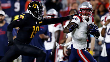 New England Patriots wide receiver Ja'Lynn Polk (1) runs after a catch against Washington Commanders cornerback Noah Igbinoghene (19) during the first quarter during a preseason game at Commanders Field. 