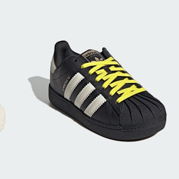 The adidas Humanrace Superstar 92 in white and black colorways.