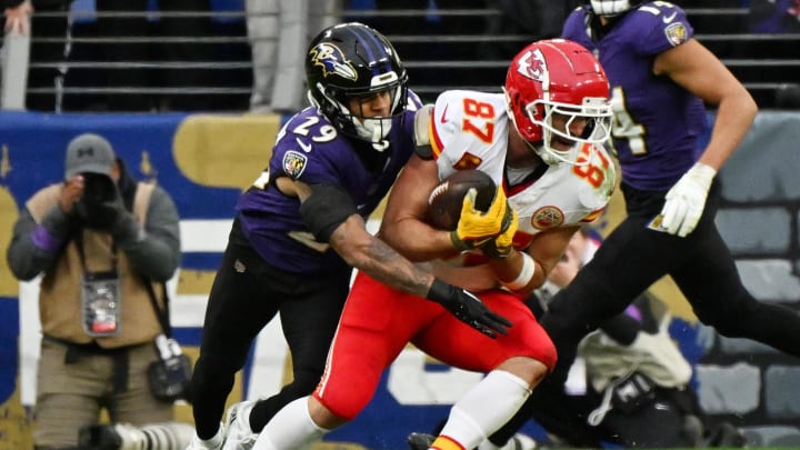 Jan 28, 2024; Baltimore, Maryland, USA; Kansas City Chiefs tight end Travis Kelce (87) runs with the ball against Baltimore Ravens safety Ar'Darius Washington (29) during the first half in the AFC Championship football game at M&T Bank Stadium. Mandatory Credit: Tommy Gilligan-USA TODAY Sports