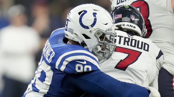 Indianapolis Colts defensive tackle DeForest Buckner (99) sacks Houston Texans quarterback C.J. Stroud (7) at Lucas Oil Stadium.