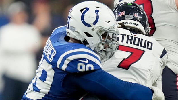 Colts defensive tackle DeForest Buckner (blue jersey; white helmet) sacks quarterback C.J. Stroud for a loss. 