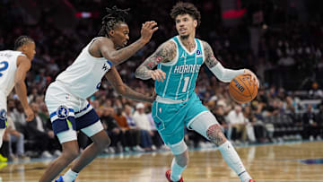Nov 1, 2025; Charlotte, North Carolina, USA; Charlotte Hornets guard LaMelo Ball (1) handles the ball against Minnesota Timberwolves guard Bones Hyland (8) during the second quarter at Spectrum Center. Mandatory Credit: Jim Dedmon-Imagn Images