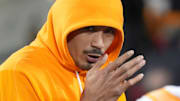 Tennessee quarterback Nico Iamaleava (8) tries to keep warm before the start of the NCAA college football playoff game against Ohio State on Saturday, Dec. 21, 2024, in Columbus, Ohio.