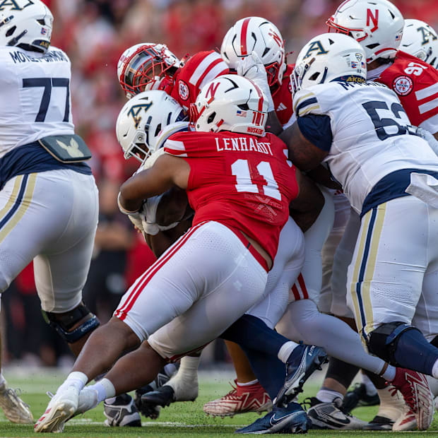 Nebraska defensive linemen Cameron Lenhardt and Elijah Jeudy combine to stop Akron's Sean Patrick.