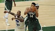 Apr 24, 2021; Milwaukee, Wisconsin, USA;  Milwaukee Bucks forward Giannis Antetokounmpo (34) grabs a rebound in front of Philadelphia 76ers center Dwight Howard (39) in the second quarter at Fiserv Forum. Mandatory Credit: Michael McLoone-Imagn Images