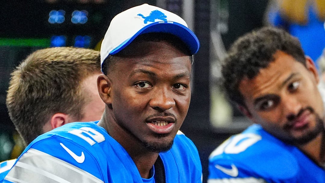 Former Detroit Lions quarterback Hendon Hooker talks to other players on the bench during the first quarter of the preseason game at Ford Field in Detroit, Saturday, Aug. 16, 2025.