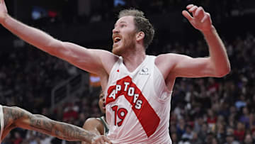 Nov 4, 2025; Toronto, Ontario, CAN; Milwaukee Bucks forward Kyle Kuzma (18) and Toronto Raptors center Jakob Poeltl (19) battle for a rebound during the second half at Scotiabank Arena. Mandatory Credit: John E. Sokolowski-Imagn Images