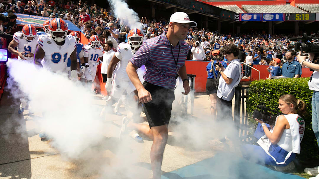 Florida head coach Jon Sumrall and the team blasts out onto the field before the Orange and Blue game at Steve Spurrier Field at Ben Hill Griffin Stadium in Gainesville, FL on Saturday, April 11, 2026. [Alan Youngblood/Gainesville Sun]