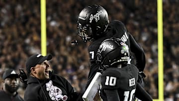 Oct 26, 2024; College Station, Texas, USA; Texas A&M Aggies quarterback Marcel Reed (10) celebrates after scoring a touchdown with Offensive Coordinator/Quarterbacks coach Collin Klein in the third quarter against the LSU Tigers at Kyle Field. Mandatory Credit: Maria Lysaker-Imagn Images. 