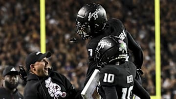 Oct 26, 2024; College Station, Texas, USA; Texas A&M Aggies quarterback Marcel Reed (10) celebrates after scoring a touchdown with Offensive Coordinator/Quarterbacks coach Collin Klein in the third quarter against the LSU Tigers at Kyle Field. Mandatory Credit: Maria Lysaker-Imagn Images. 