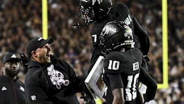 Texas A&M Aggies quarterback Marcel Reed celebrates after scoring a touchdown with Offensive Coordinator Collin Klein 
