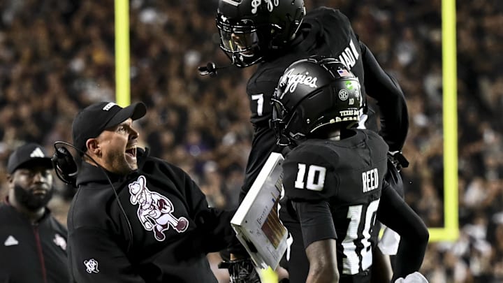Texas A&M Aggies quarterback Marcel Reed celebrates after scoring a touchdown with Offensive Coordinator Collin Klein 