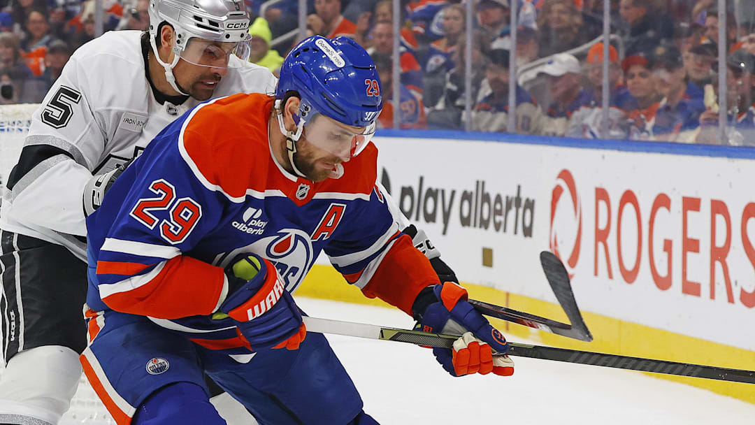 Jan 10, 2026; Edmonton, Alberta, CAN; Edmonton Oilers forward Leon Draisaitl (29) and Los Angeles Kings defensemen Cody Ceci (5) battle along the boards for a loose puck at Rogers Place. Mandatory Credit: Perry Nelson-Imagn Images