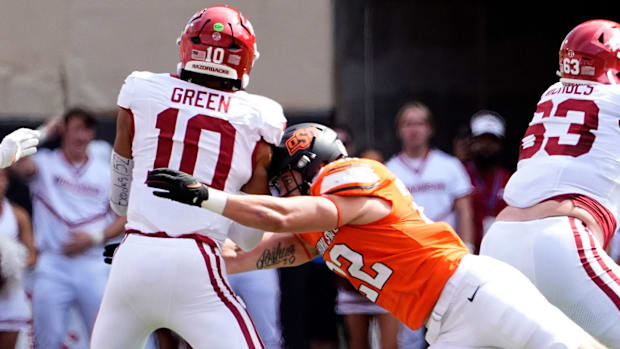 Oklahoma State's Jeff Roberson and Collin Oliver sack Arkansas' Taylen Green.