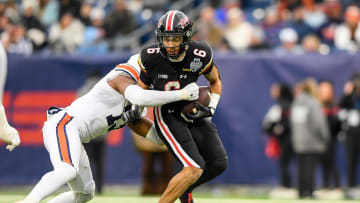 Dec 30, 2023; Nashville, TN, USA;  Auburn Tigers linebacker Cam Riley (13) tackles Maryland Terrapins wide receiver Jeshaun Jones (6) during the first half at Nissan Stadium. Mandatory Credit: Steve Roberts-USA TODAY Sports