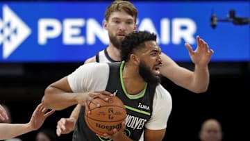 Mar 1, 2024; Minneapolis, Minnesota, USA; Minnesota Timberwolves forward Karl-Anthony Towns (32) works around Sacramento Kings center Domantas Sabonis (10) in the first quarter at Target Center. Mandatory Credit: Bruce Kluckhohn-Imagn Images