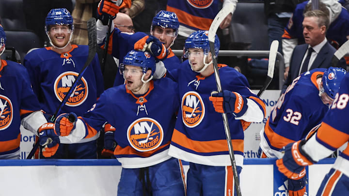 Apr 27, 2024; Elmont, New York, USA; New York Islanders center Mathew Barzal (13) celebrates with defenseman Noah Dobson (8) after scoring a goal in the second period against the Carolina Hurricanes in game four of the first round of the 2024 Stanley Cup Playoffs at UBS Arena. Mandatory Credit: Wendell Cruz-Imagn Images