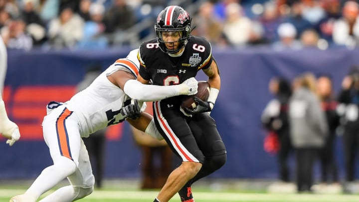 Dec 30, 2023; Nashville, TN, USA;  Auburn Tigers linebacker Cam Riley (13) tackles Maryland Terrapins wide receiver Jeshaun Jones (6) during the first half at Nissan Stadium. Mandatory Credit: Steve Roberts-USA TODAY Sports