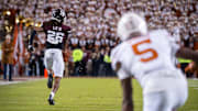 Texas Longhorns wide receiver Ryan Wingo (5) watches as Texas A&M Aggies defensive back Will Lee III (26) runs the ball in to score a touchdown after an interception in the third quarter of the Lone Star Showdown at Kyle Field. 