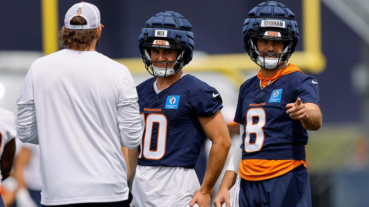 Jul 26, 2024; Englewood, CO, USA; Denver Broncos quarterback Jarrett Stidham (8) and quarterback Bo Nix (10) and quarterback Zach Wilson (4) during training camp at Broncos Park Powered by CommonSpirit. 