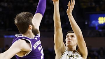 Jan 19, 2025; Ann Arbor, Michigan, USA; Michigan Wolverines center Vladislav Goldin (50) shoots over Northwestern Wildcats center Matthew Nicholson (34) in the first half at Crisler Center. Mandatory Credit: Rick Osentoski-Imagn Images