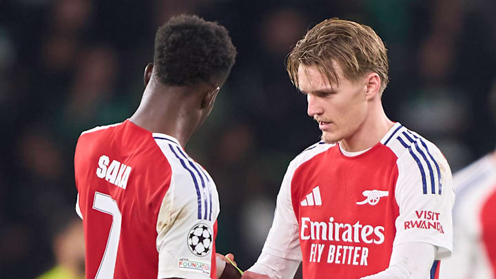 Martin Ødegaard (right) passes the captain's armband to Bukayo Saka (left) in the team's victory over Sporting. Martin Ødegaard (right) passes the captain's armband to Bukayo Saka (left) in the team's victory over Sporting.