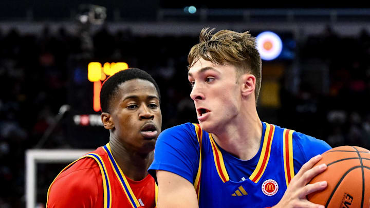 Apr 2, 2024; Houston, TX, USA; McDonald's All American East forward Cooper Flagg (32) controls the ball as McDonald's All American West guard Valdez Edgecombe Jr (7) defends during the first half at Toyota Center. Mandatory Credit: Maria Lysaker-Imagn Images