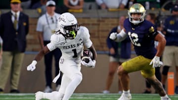 Sep 13, 2025; South Bend, Indiana, USA; Texas A&M Aggies wide receiver Mario Craver (1) runs the ball against Notre Dame Fighting Irish defensive lineman Jordan Botelho (12) during the first half at Notre Dame Stadium. Mandatory Credit: Trevor Ruszkowski-Imagn Images