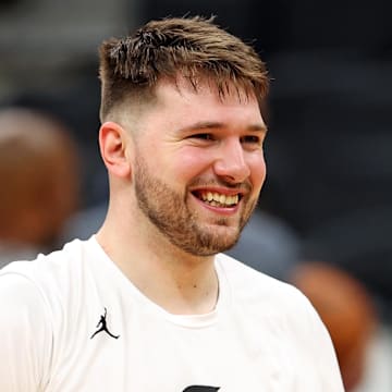 Jun 5, 2024; Boston, MA, USA;  Dallas Mavericks guard Luka Doncic (77) laughs with teammates during the NBA Finals Media Day at TD Garden. Mandatory Credit: Peter Casey-Imagn Images