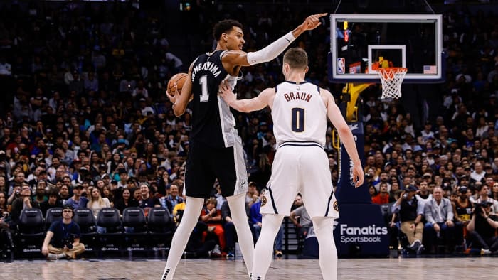 Apr 2, 2024; Denver, Colorado, USA; San Antonio Spurs center Victor Wembanyama (1) gestures as he is defended by Denver Nuggets guard Christian Braun (0)