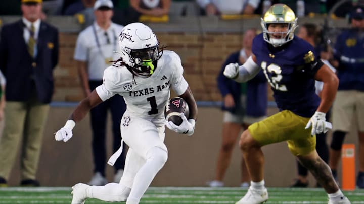 Sep 13, 2025; South Bend, Indiana, USA; Texas A&M Aggies wide receiver Mario Craver (1) runs the ball against Notre Dame Fighting Irish defensive lineman Jordan Botelho (12) during the first half at Notre Dame Stadium. Mandatory Credit: Trevor Ruszkowski-Imagn Images