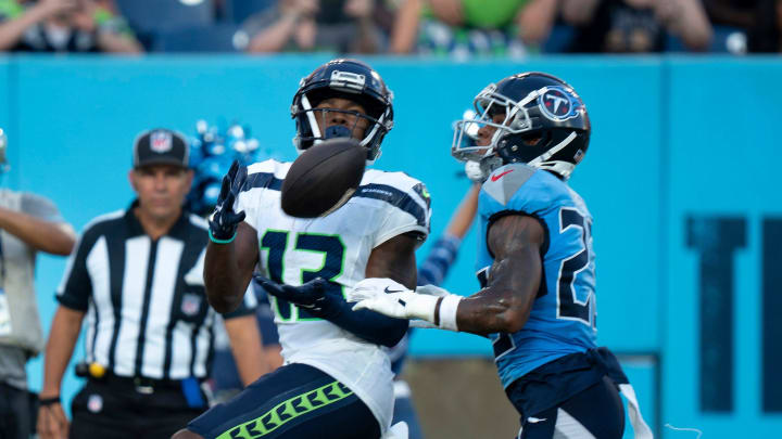 Seattle Seahawks wide receiver Easop Winston Jr. (13) hauls in a touchdown pass ahead of Tennessee Titans cornerback Tre Avery (23) during their game at Nissan Stadium in Nashvillet, Tenn., Saturday, Aug. 17, 2024.