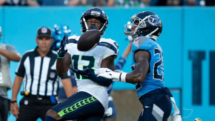 Seattle Seahawks wide receiver Easop Winston Jr. (13) hauls in a touchdown pass ahead of Tennessee Titans cornerback Tre Avery (23) during their game at Nissan Stadium in Nashvillet, Tenn., Saturday, Aug. 17, 2024.