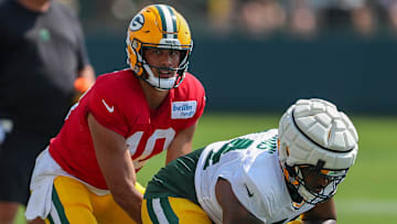 Green Bay Packers quarterback Jordan Love (10) takes a snap from offensive lineman Elgton Jenkins (74) during the eighth practice of training camp on Wednesday, July 31, 2024, at Ray Nitschke Field in Ashwaubenon, Wis.