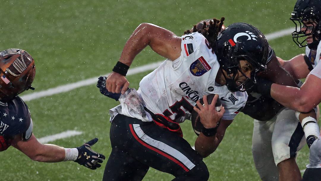 Jan 2, 2026; Memphis, TN, USA; Cincinnati Bearcats quarterback Samaj Jones (5) runs the ball during the second quarter against the Navy Midshipmen at Simmons Bank Liberty Stadium. Mandatory Credit: Petre Thomas-Imagn Images