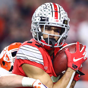 Dec 28, 2019; Glendale, AZ, USA; Ohio State Buckeyes wide receiver Chris Olave (17) catches a pass for a touchdown against Clemson Tigers safety Nolan Turner (24) during the fourth quarter in the 2019 Fiesta Bowl college football playoff semifinal game at State Farm Stadium. Mandatory Credit: Matthew Emmons-Imagn Images