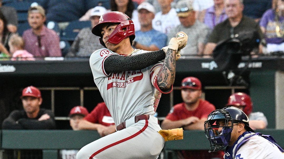 Jun 18, 2025; Omaha, Neb, USA;  Arkansas Razorbacks shortstop Wehiwa Aloy (9) singles against the LSU Tigers during the eighth inning at Charles Schwab Field. Mandatory Credit: Steven Branscombe-Imagn Images