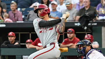 Jun 18, 2025; Omaha, Neb, USA;  Arkansas Razorbacks shortstop Wehiwa Aloy (9) singles against the LSU Tigers during the eighth inning at Charles Schwab Field. Mandatory Credit: Steven Branscombe-Imagn Images