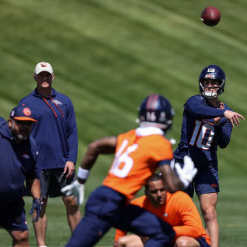 May 23, 2024; Englewood, CO, USA; Denver Broncos quarterback Bo Nix (10) passes to wide receiver Troy Franklin (16) during organized team activities at Centura Health Training Center. 