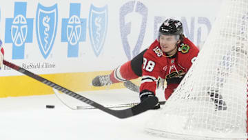 Dec 10, 2025; Chicago, Illinois, USA; Chicago Blackhawks center Connor Bedard (98) dives for the puck against the New York Rangers during the first period at United Center. Mandatory Credit: David Banks-Imagn Images