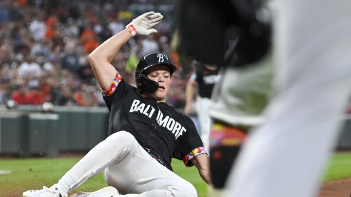 Aug 16, 2024; Baltimore, Maryland, USA;  Baltimore Orioles second baseman Jackson Holliday (7) slides to score on third baseman Ramon Urias (not pictured) RBI single against the Boston Red Sox at Oriole Park at Camden Yards. 