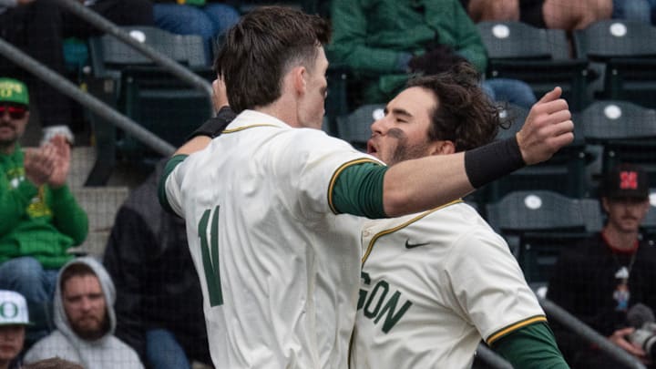 Oregon’s Angel Laya, right, celebrates second-inning homer with Brayden Jaksa, left, against Nebraska at PK Park in Eugene April 12, 2026.