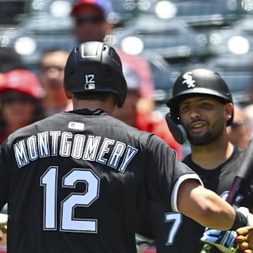 Chicago White Sox catcher Edgar Quero (7) celebrates with shortstop Colson Montgomery (12) and center fielder Luis Robert Jr. (88) after scoring a run against the Los Angeles Angels at Angel Stadium. 