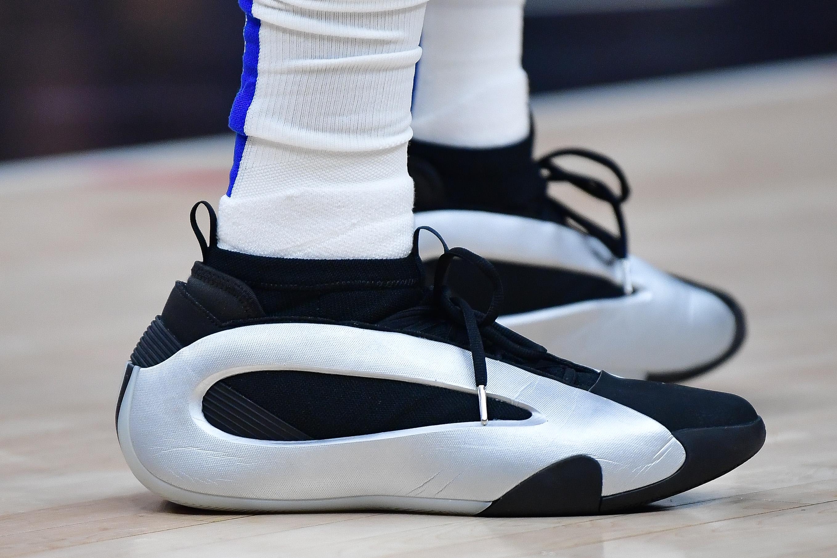 Los Angeles Clippers guard James Harden's silver and black adidas sneakers.