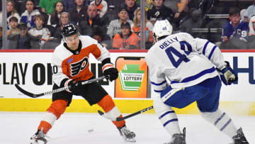 Mar 14, 2024; Philadelphia, Pennsylvania, USA; Philadelphia Flyers right wing Bobby Brink (10) and Toronto Maple Leafs defenseman Morgan Rielly (44) battle for the puck during the first period at Wells Fargo Center. Mandatory Credit: Eric Hartline-USA TODAY Sports